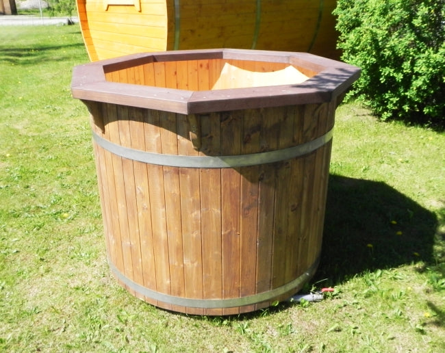 Viking Industrier 1.2m Cold Tub with light brown octagonal rim and vertical wood panels placed on green grass in an outdoor setting with sunlight.