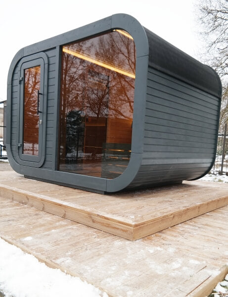 Exterior front angle of Viking Industrier Luna Outdoor Sauna 3.3 x 2.4m with full glass wall and black wood finish.