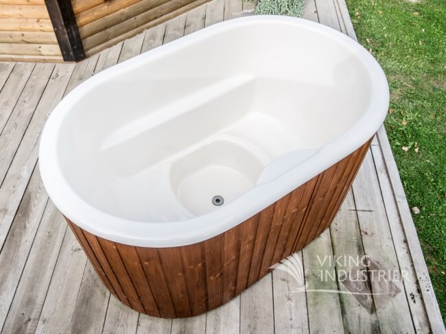 Top-down view of the Viking Industrier Ofuro hot tub with a white fiberglass interior, placed on a wooden deck outdoors.