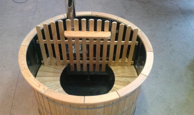 Top view of Viking Industrier Polypropylene hot tub with protective heater partition and wooden seating, indoors on a concrete floor.