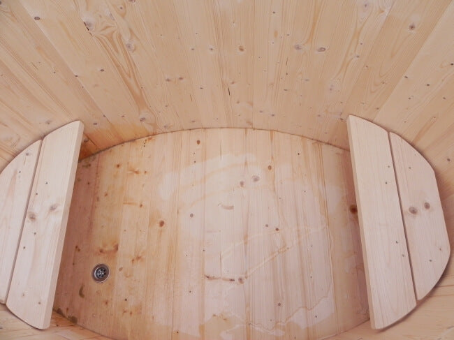 Interior view of Viking Industrier oval cold tub made of light spruce wood with dual bench seats, photographed from above.