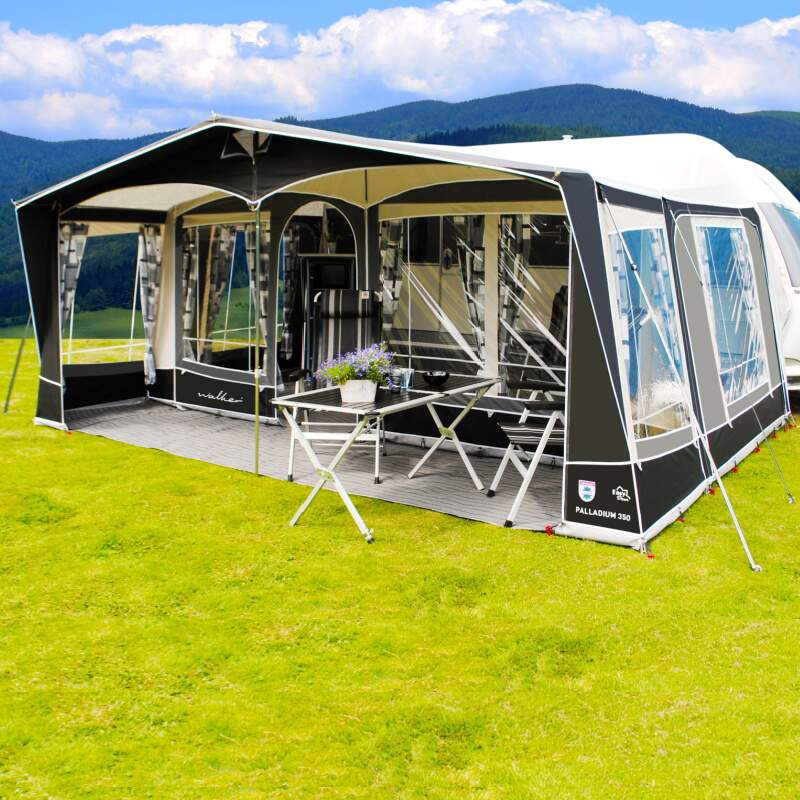 A Walker Palladium Awning with a front porch and table and chairs