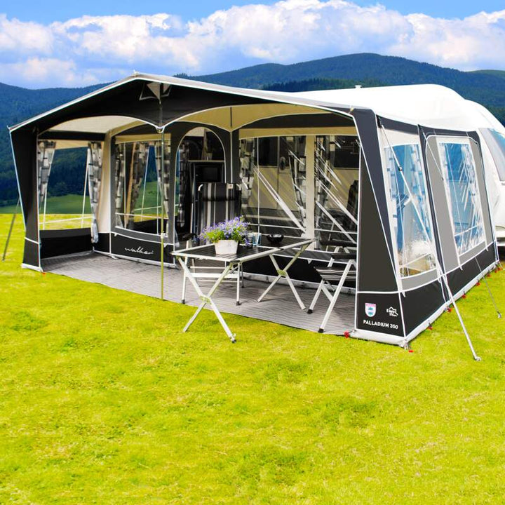 A Walker Palladium Awning with a front porch and table and chairs