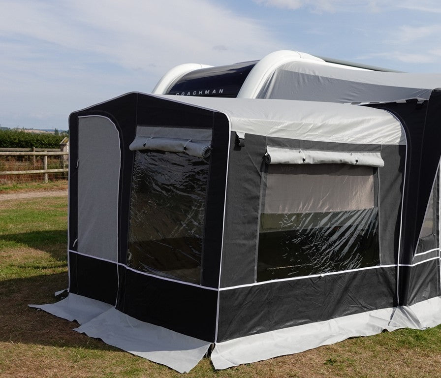 Camptech Westminster CS Tall Annex in grey and black attached to a caravan outdoor field.