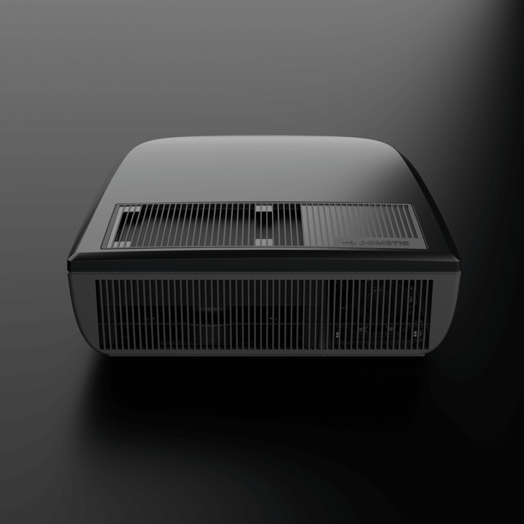 Front view of the Dometic FreshJet FJX7 2200 in black, with prominent ventilation grills and smooth matte finish, on a dark background.
