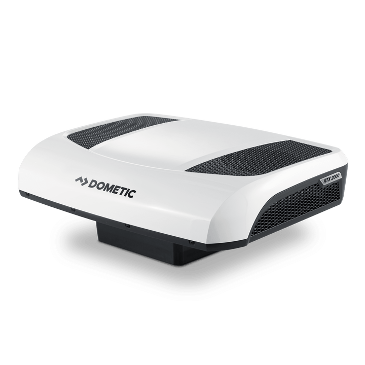Angled front-right view of the Dometic CoolAir RTX 2000 12V unit. Features a contoured white body with large black mesh ventilation areas and a visible 'RTX 2000' badge on the side, on a transparent background.