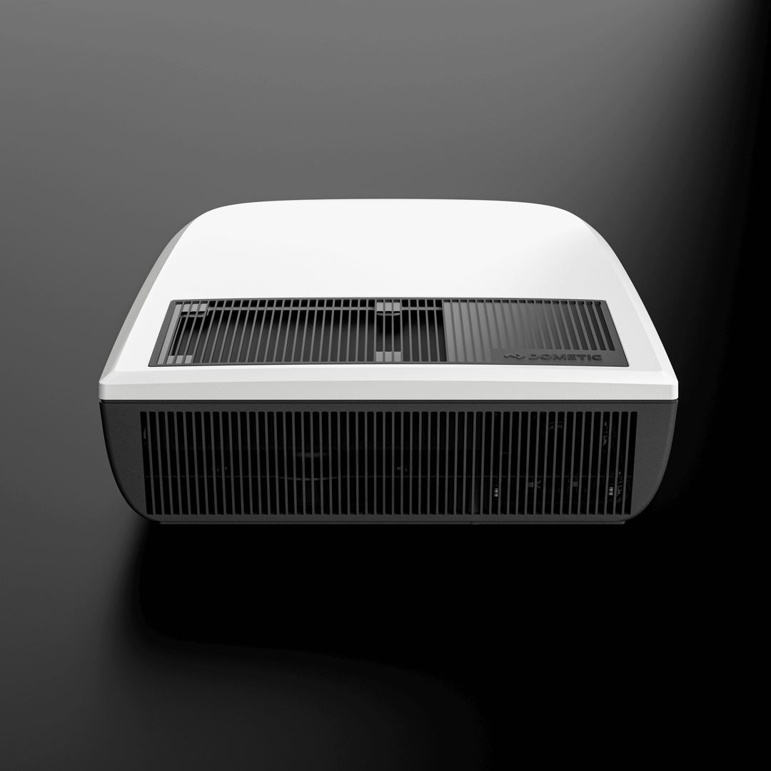 Front view of the white Dometic FreshJet FJX4 1700 rooftop unit, showcasing the central vent system and curved body on a dark background.