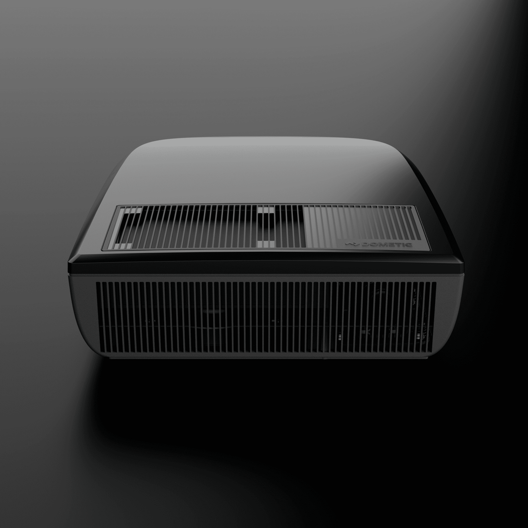 Front view of the black Dometic FreshJet FJX4 2200 rooftop air conditioner with prominent ventilation grills,  on a dark background.
