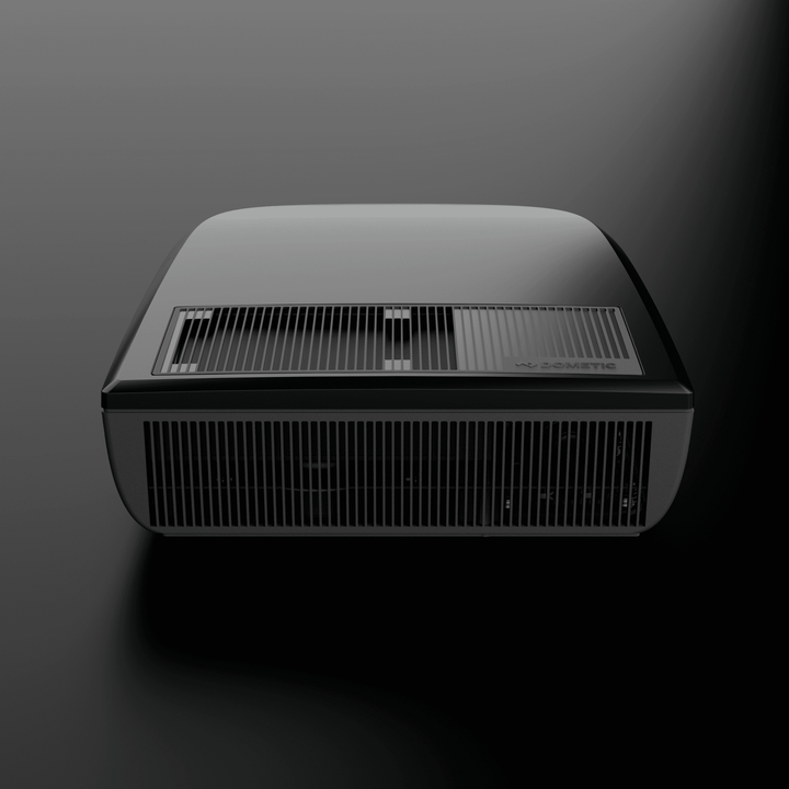 Front view of the black Dometic FreshJet FJX4 2200 rooftop air conditioner with prominent ventilation grills,  on a dark background.