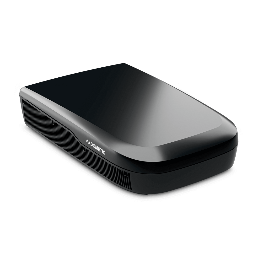 Angled view of the Dometic FreshJet FJX7 3000 in black. The unit’s aerodynamic, glossy top and side grilles with a transparent background.