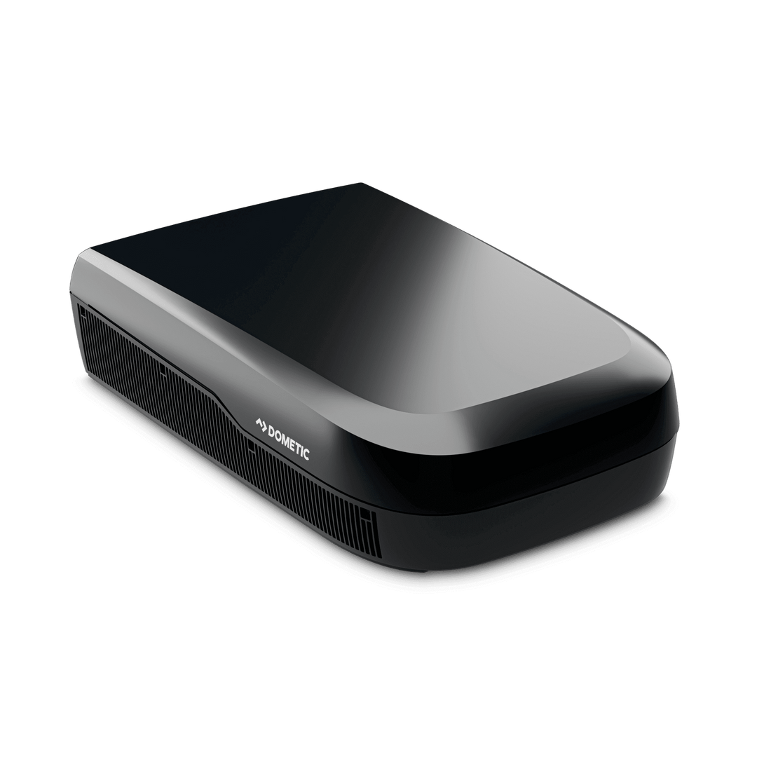 Angled front-side view of the Dometic FreshJet FJX7 3500 in black. Shows off its curved aerodynamic body, side ventilation grilles, and subtle Dometic logo, on a transparent background.