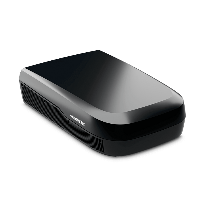 Angled front-side view of the Dometic FreshJet FJX7 3500 in black. Shows off its curved aerodynamic body, side ventilation grilles, and subtle Dometic logo, on a transparent background.