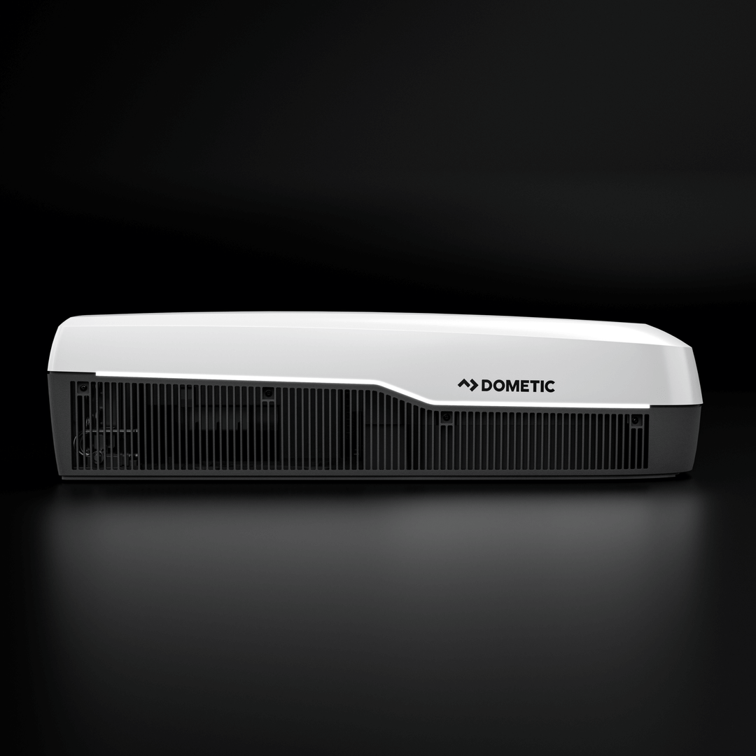 Side profile of the white Dometic FreshJet FJX7 3500 air conditioner. Elegant white and grey contrast with horizontal ventilation grilles, with a plain black background