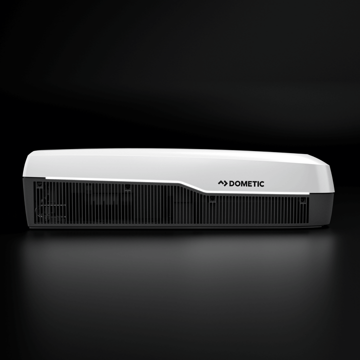 Side profile of the white Dometic FreshJet FJX7 3500 air conditioner. Elegant white and grey contrast with horizontal ventilation grilles, with a plain black background