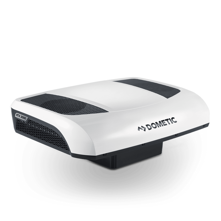 Angled rear-left perspective of the Dometic CoolAir RTX 2000 12V. Highlights aerodynamic contours, RTX 2000 side badge, and prominent rear ventilation grilles, on a transparent background.