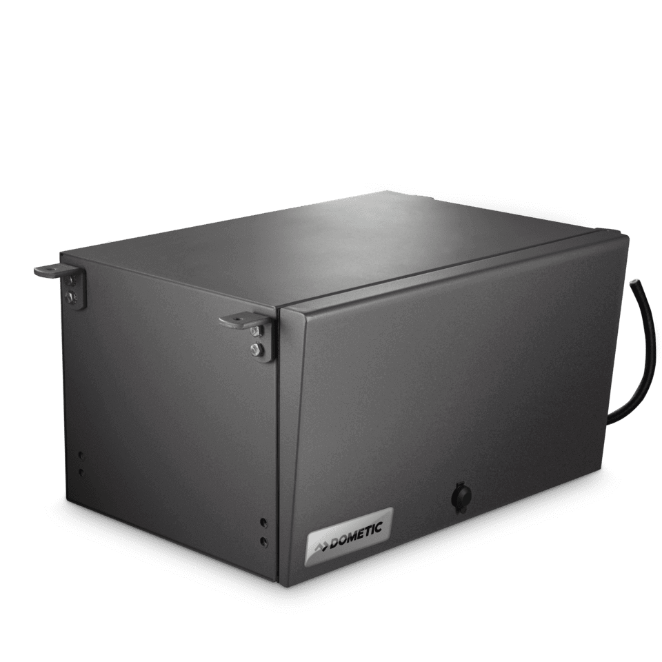 Angled view of the fully enclosed Dometic T 2500H petrol generator in its matte gray steel casing. Minimalistic design with lock mechanism and corner mounting brackets visible. DOMETIC logo on the front, on a transparent background.