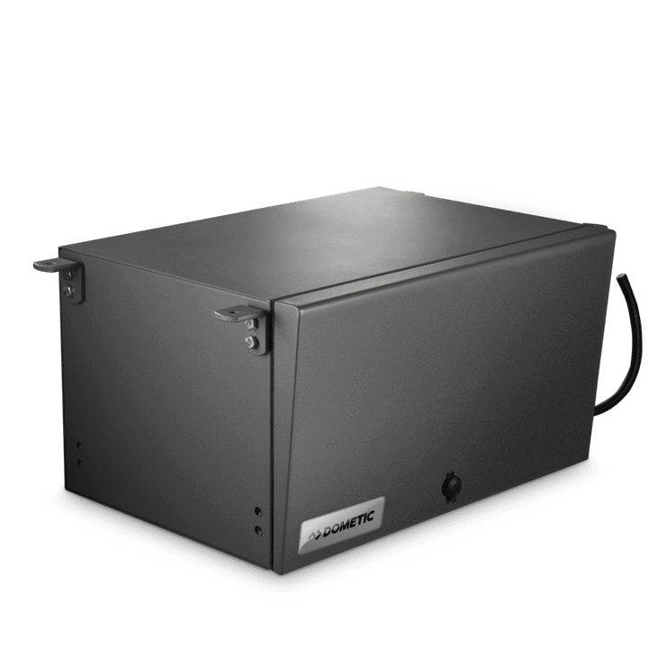 Angled view of the fully enclosed Dometic T 2500H petrol generator in its matte gray steel casing. Minimalistic design with lock mechanism and corner mounting brackets visible. DOMETIC logo on the front, on a transparent background.