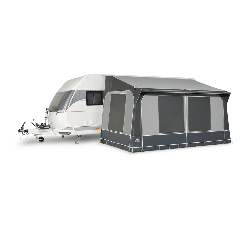 Dorema Quartz 330 Deluxe attached to a white touring caravan, featuring enclosed grey panels, large tinted windows, and a full-length canopy on a white background.