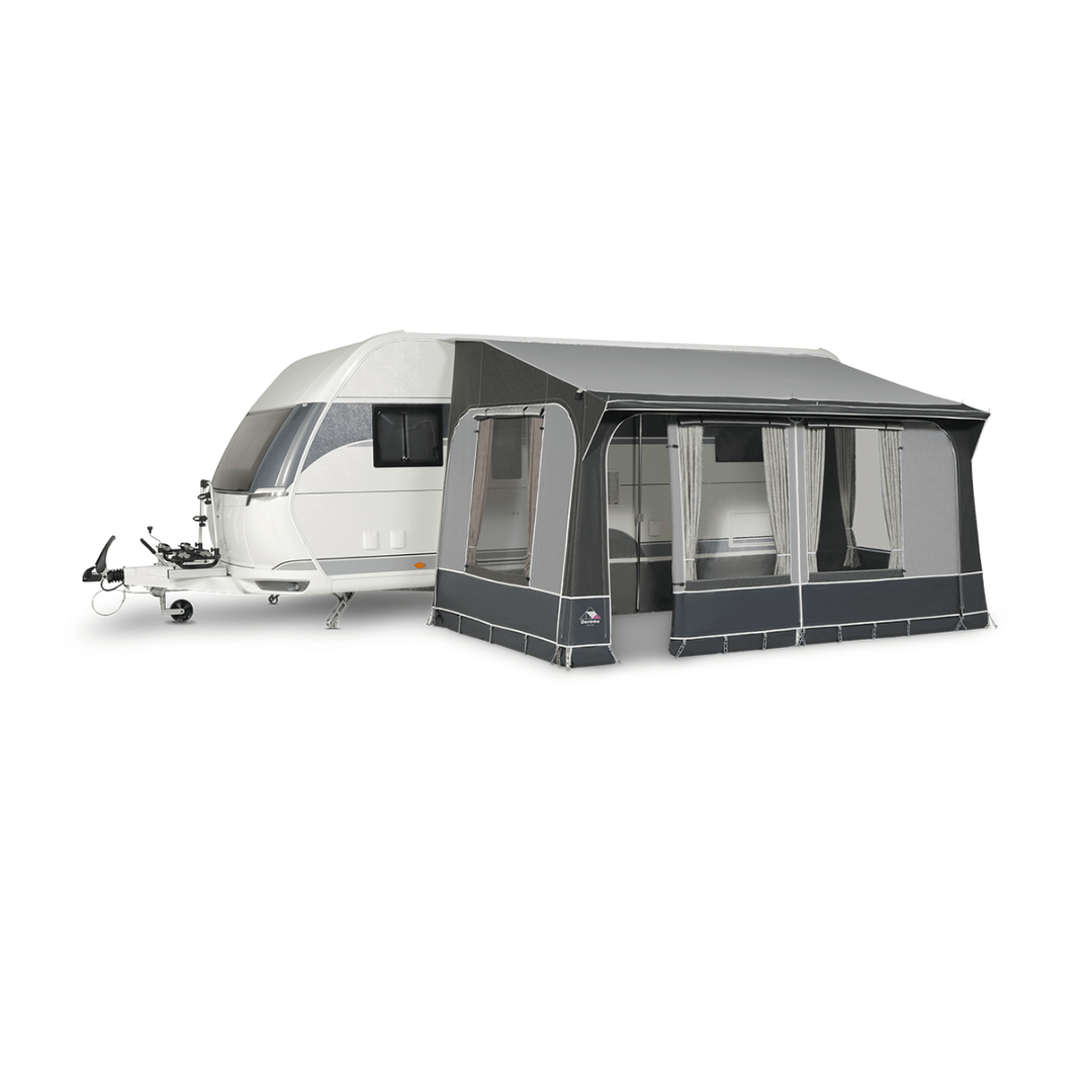 Dorema Quartz 330 attached to a white touring caravan, featuring a dark grey canopy, large clear windows, and a side entrance on a white background.
