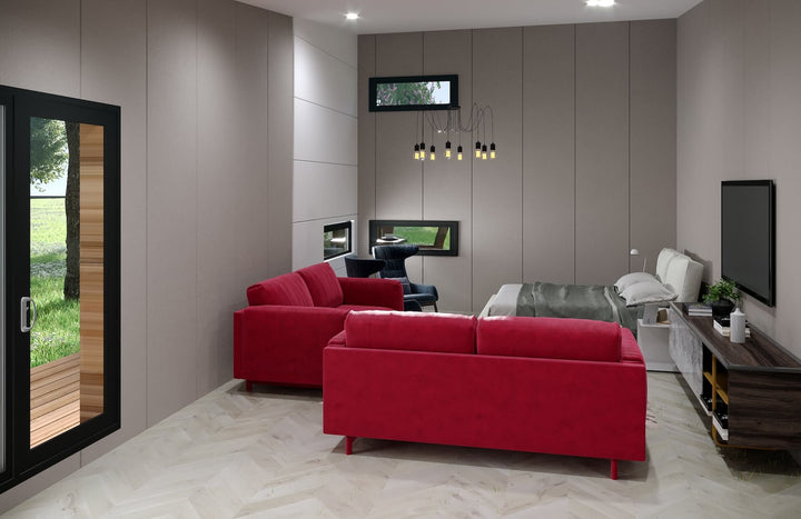 Stylish studio interior featuring a red sofa set, a bed, wall-mounted TV, and large windows bringing in natural light.