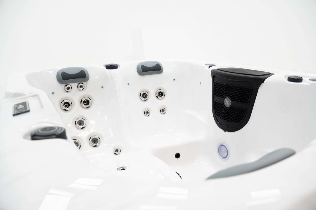 Interior view of Luso Spas The Eden Hot Tub showing hydrotherapy jets, black waterfall feature, and cushioned headrests on a white background.