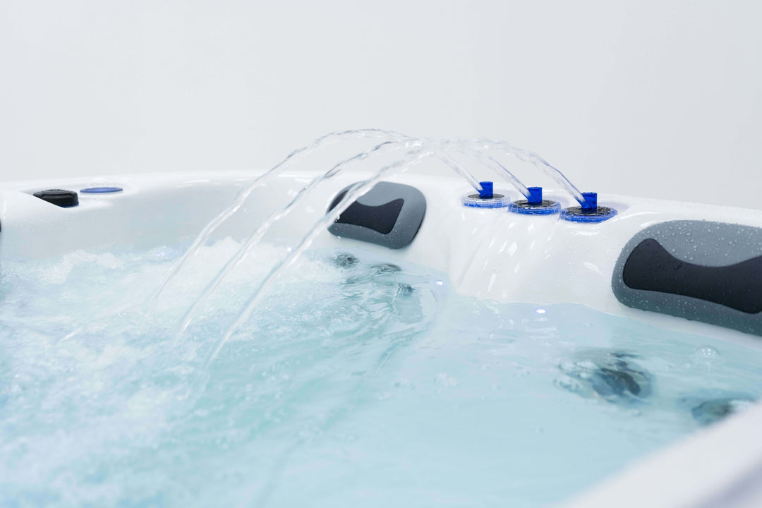 Close-up of Luso Spas The Eden Hot Tub water fountains in operation, showing clear water jets and headrests.