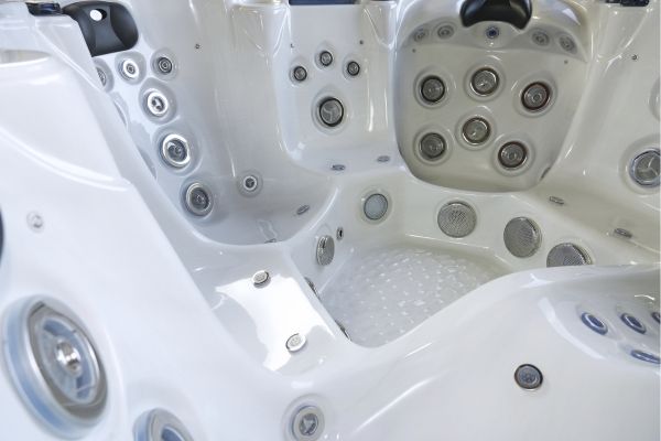 Interior view of Luso Spas The Platinum 7 Hot Tub in white acrylic with multiple jets and headrests, on a white background.
