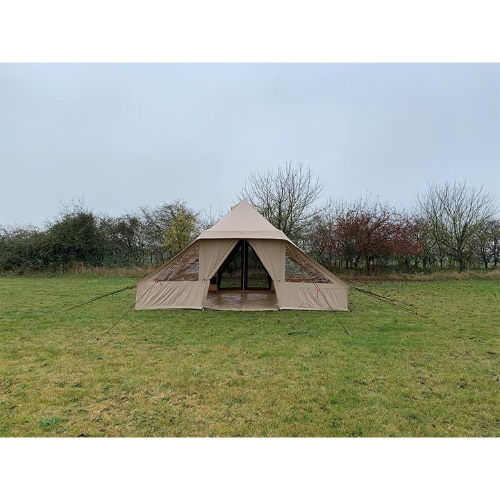 Quest Leisure Signature Touareg bell tent set up on a grassy field with trees in the background, under an overcast sky.