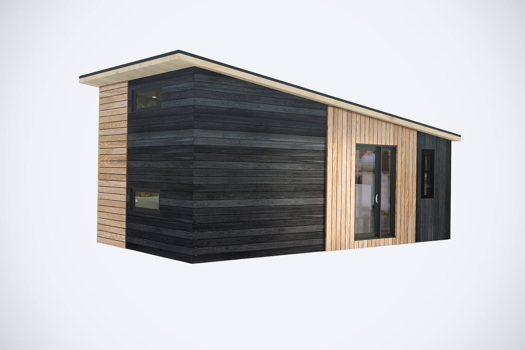 3D render of a modern small cabin with black and natural wood vertical cladding and a sloped roof, on a white background.