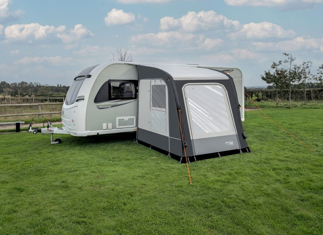 Camptech Starline 200 inflatable caravan porch awning attached to a white caravan on a grassy campsite.