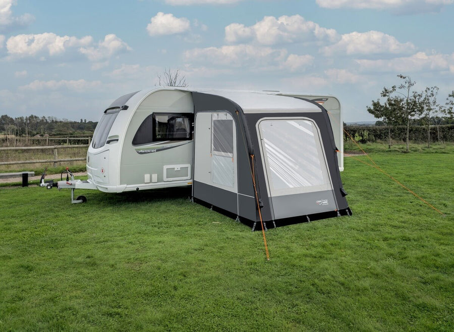 Camptech Starline 200 inflatable caravan porch awning attached to a white caravan on a grassy campsite.