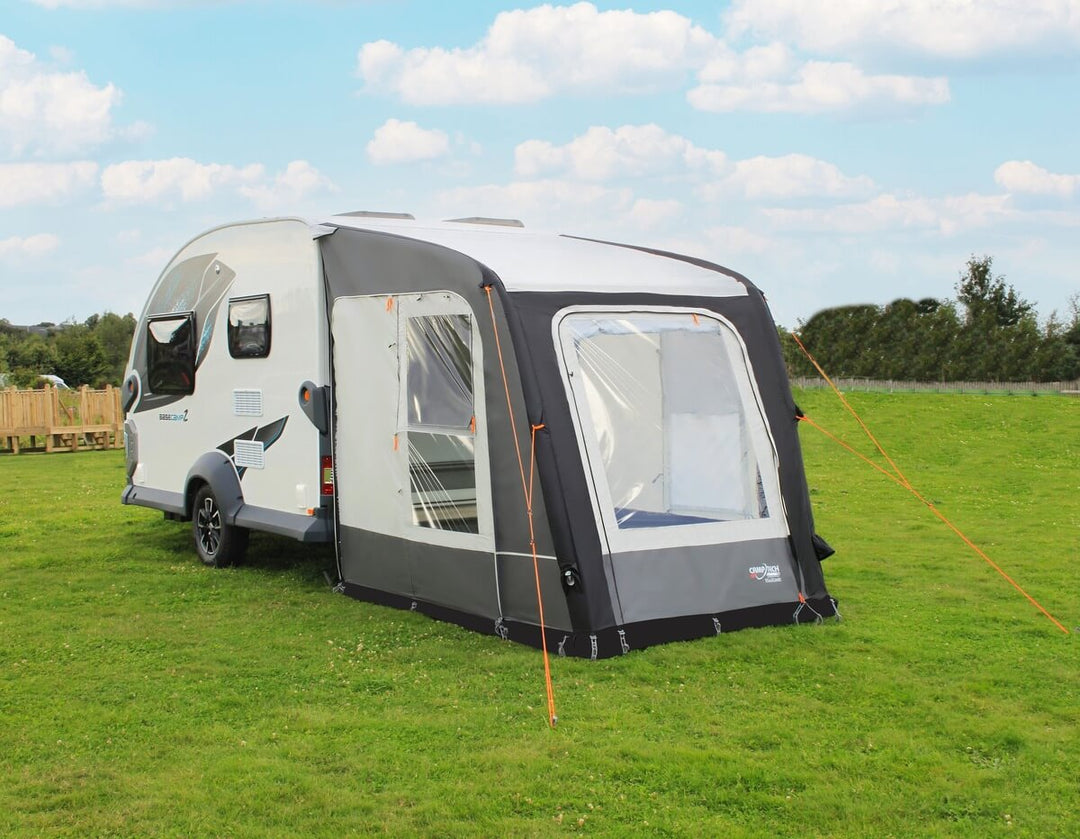 Camptech Starline 200 air awning set up beside a touring caravan in an open outdoor camping area.