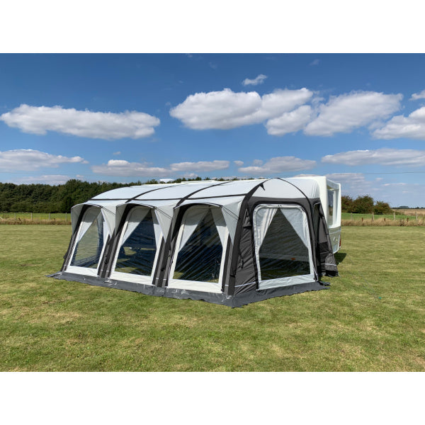 A Sunncamp Icon Air Caravan Awning shown head-on, displaying the symmetrical design of four sections with clear windows and black framework