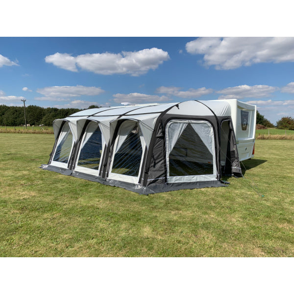 A Sunncamp Icon Air front view highlighting the transparent window panels and structural black beams, set against a countryside background