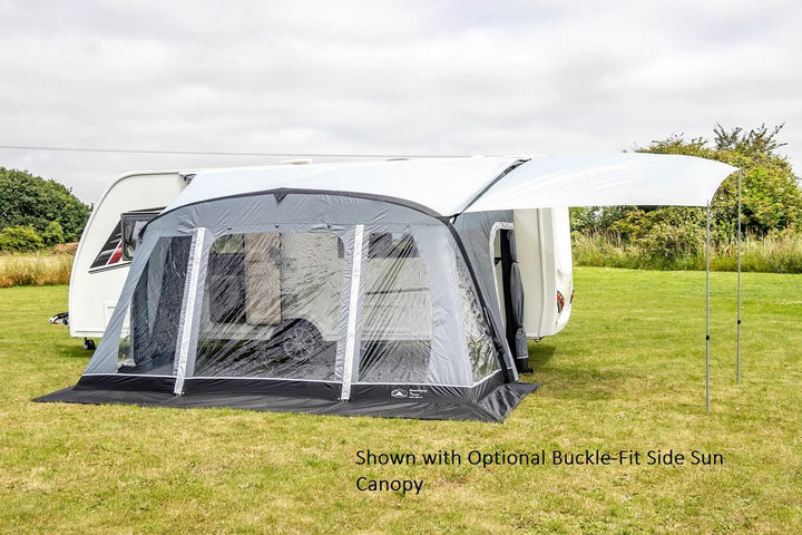 SunnCamp Swift Air 390 SC awning attached to a white caravan, featuring an extended side canopy supported by poles over a grassy campsite.