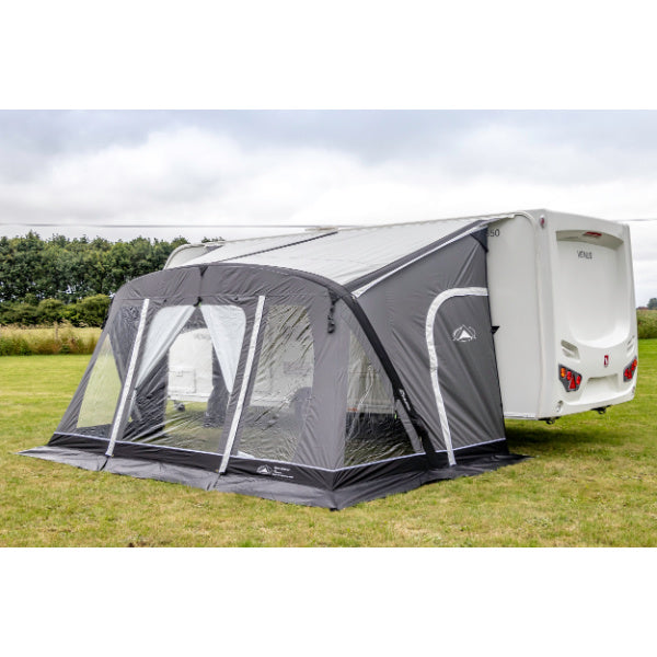 Side angled view of grey caravan awning showing full attachment to white Venus caravan on grassy field