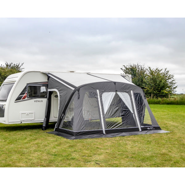 Grey caravan awning attached to Venus caravan showing front view on grass with cloudy sky background