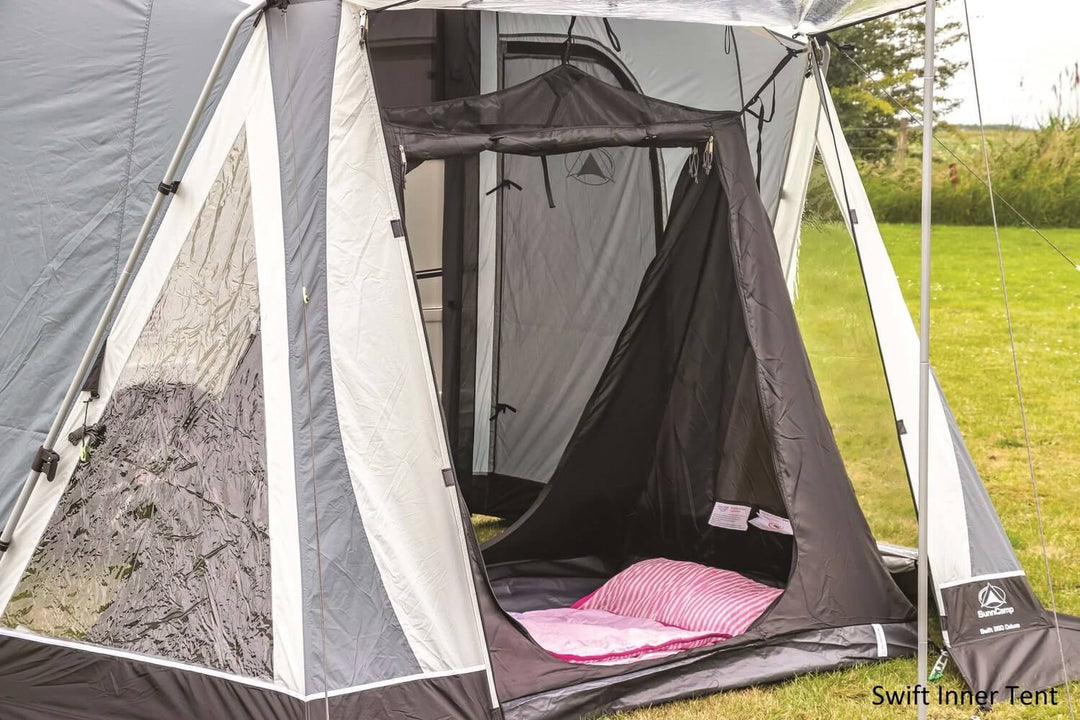 SunnCamp Swift Air 390 SC inner tent with a black zippered entrance, grey fabric walls and pink bedding inside the awning.