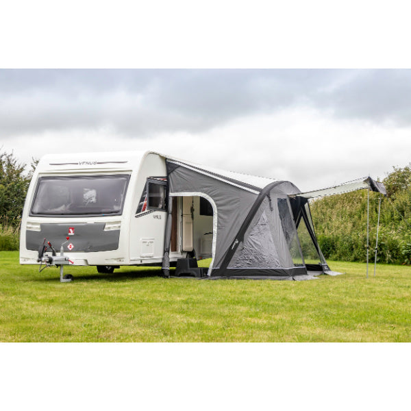 Side profile view of Swift Air Extreme awning connected to white Venus caravan on camping ground