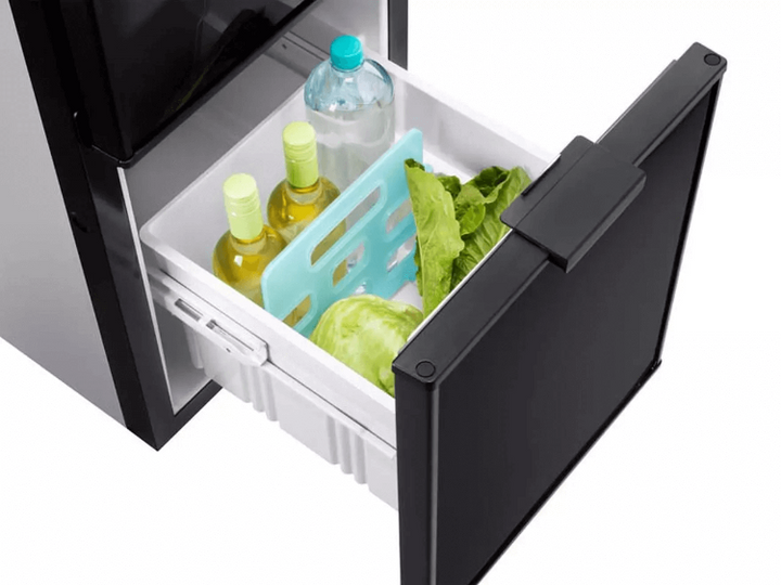 Thetford THET.FRIDGE N4141A FLAT FRAMED – Drawer compartment extended with green bottles and vegetables inside, in a silver and black fridge unit, in a white background.