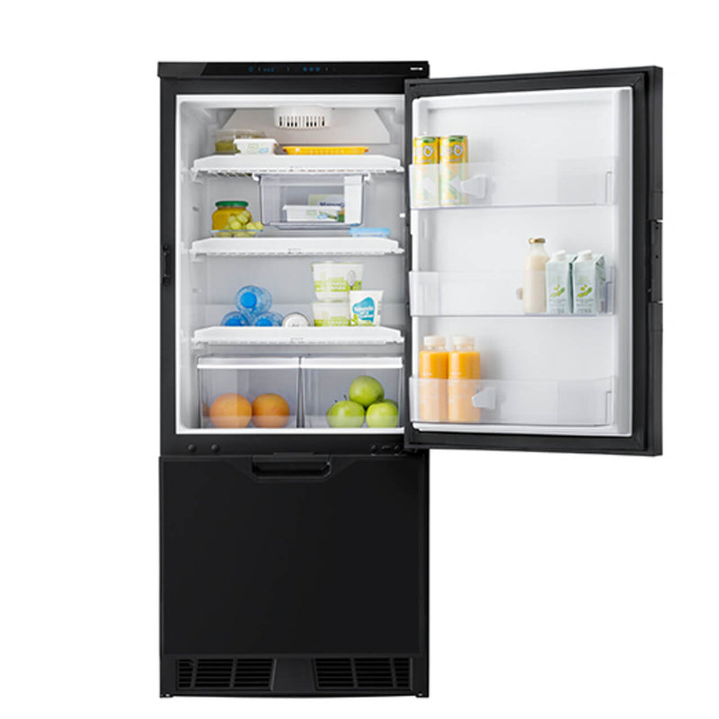 Thetford T2160 12V fridge with door open showing neatly arranged groceries inside, including fruits, dairy, and drinks, on a white background.