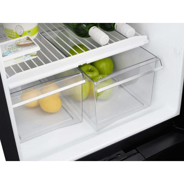 Close-up of the vegetable drawer section inside the Thetford T2175 12V fridge, showing green apples and lemons in clear bins, on a white background.