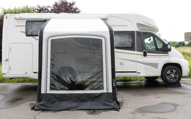 Westfield Vega 200 inflatable motorhome awning attached to a white campervan with large front windows.