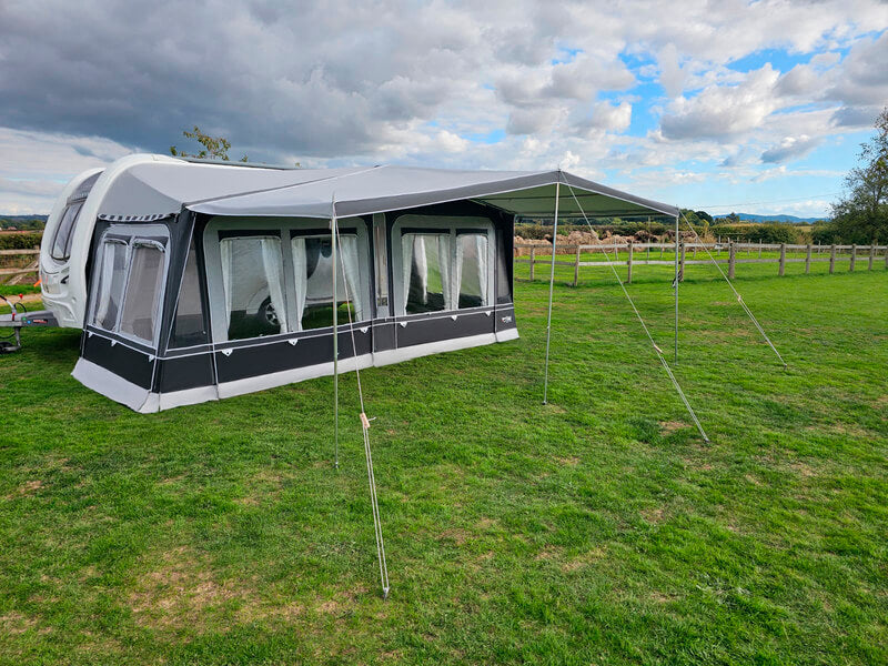 Camptech Westminster Awning with extended front canopy set up on grassy campsite.